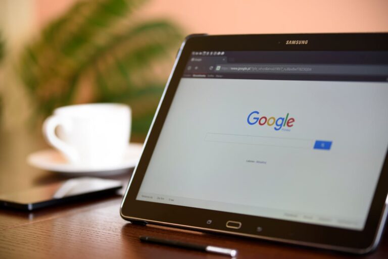 Black Samsung Tablet on Google Page with a cup of coffee and a mobile phone in the background, by PhotoMIX Company.